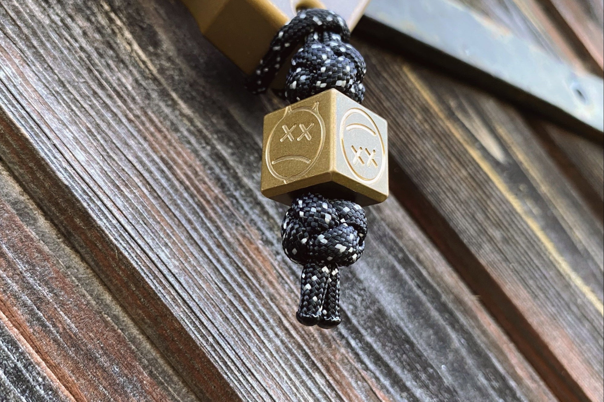 Close-up of the industrial tumbled texture on the brass EDC cube bead.-1