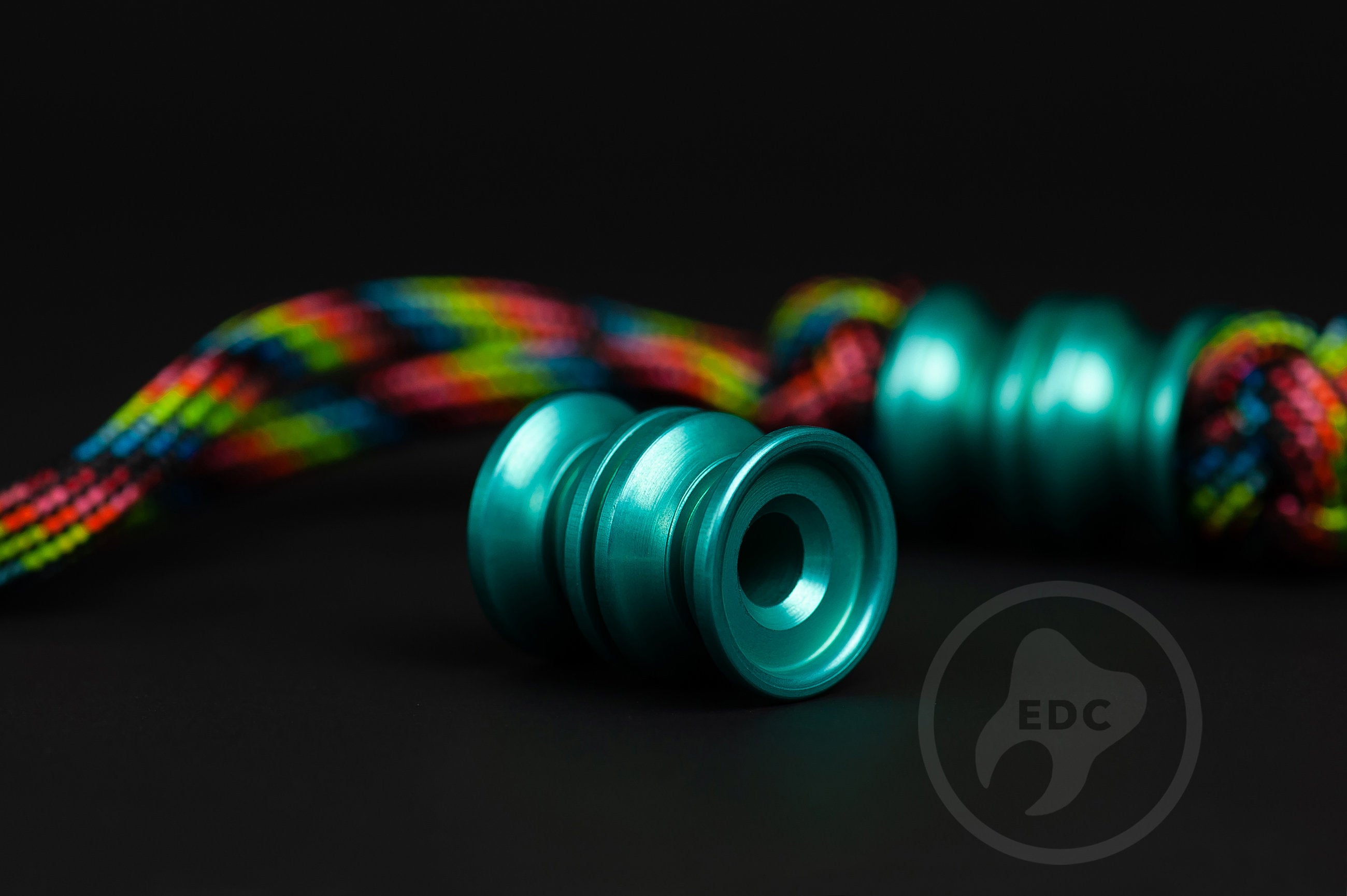 Teal anodized aluminum Grooved Barrel EDC lanyard bead.