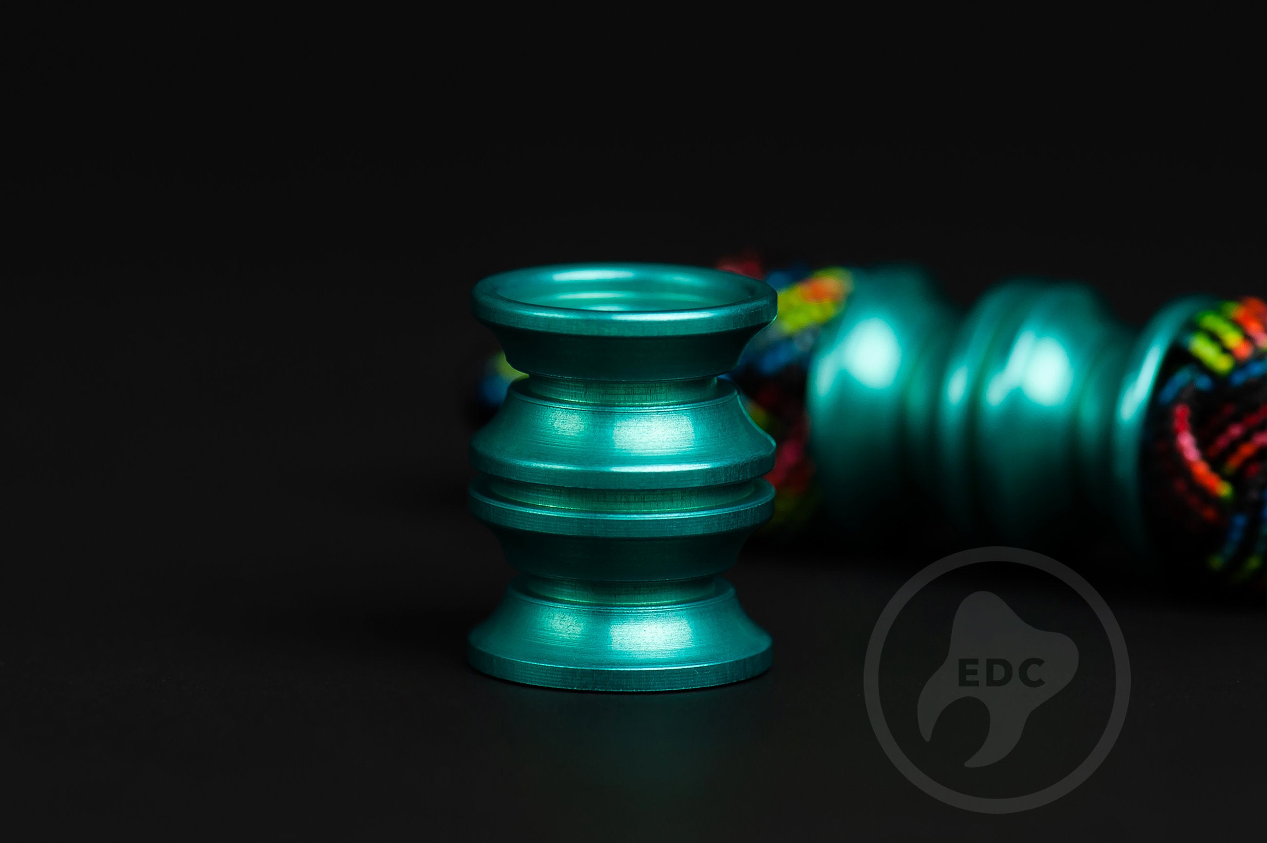 Bright teal metal lanyard bead for custom tools and gear setups.