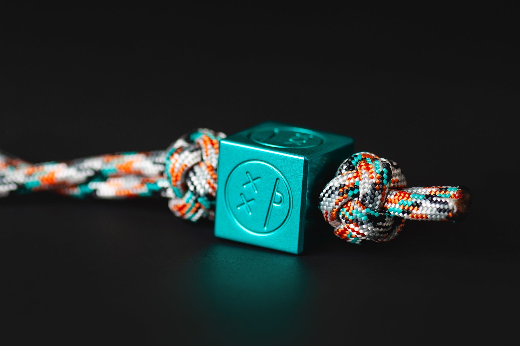 Teal Type II anodized aluminum Sad Face Cube bead.