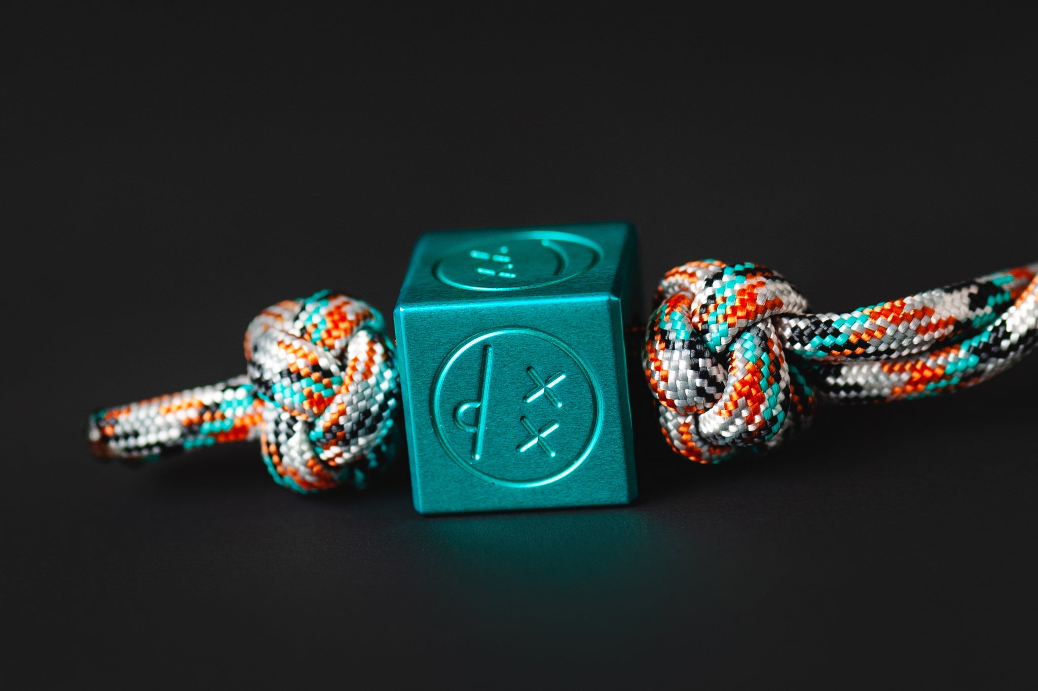 Teal aluminum Sad Face bead showing the top 6mm hole.