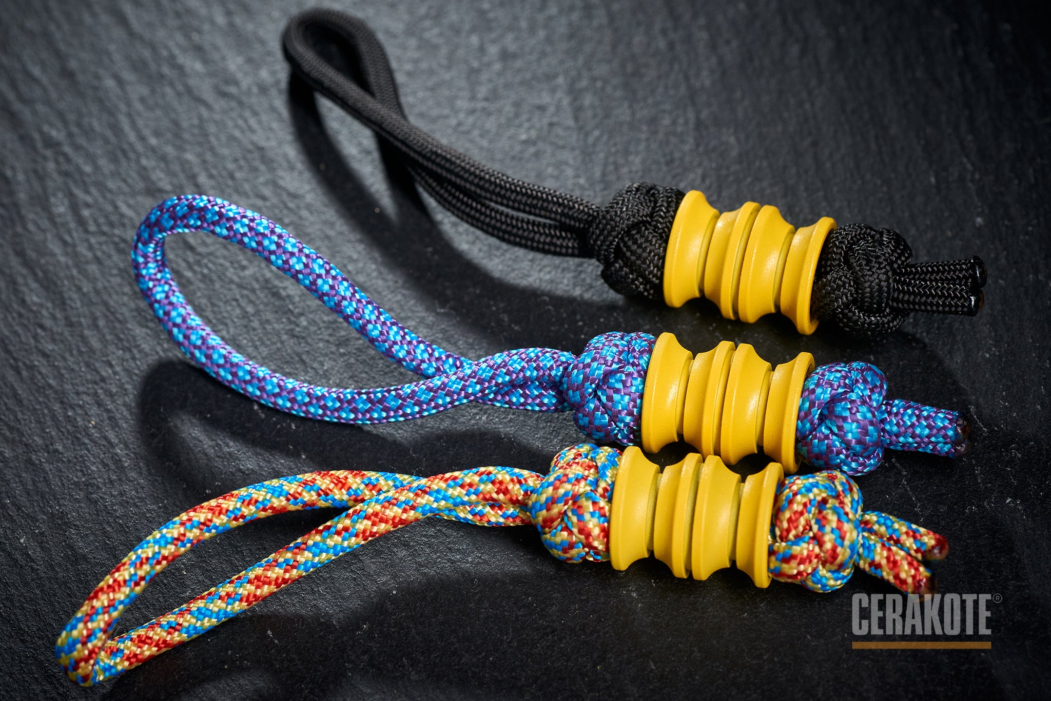 Yellow Grooved Barrel bead attached to a black paracord lanyard.-1