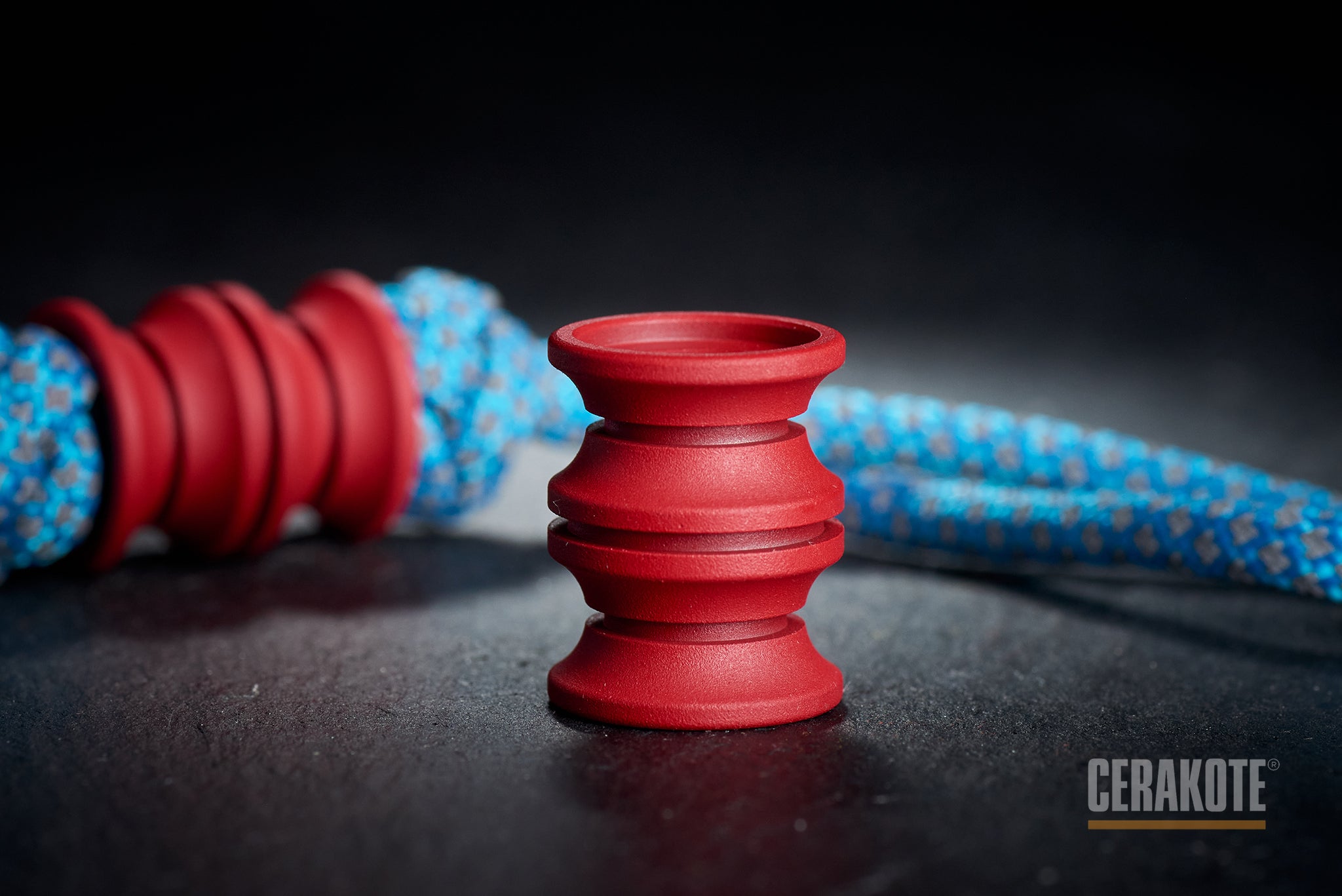 Ribbed texture of H-306 Red Cerakote on a titanium bead.