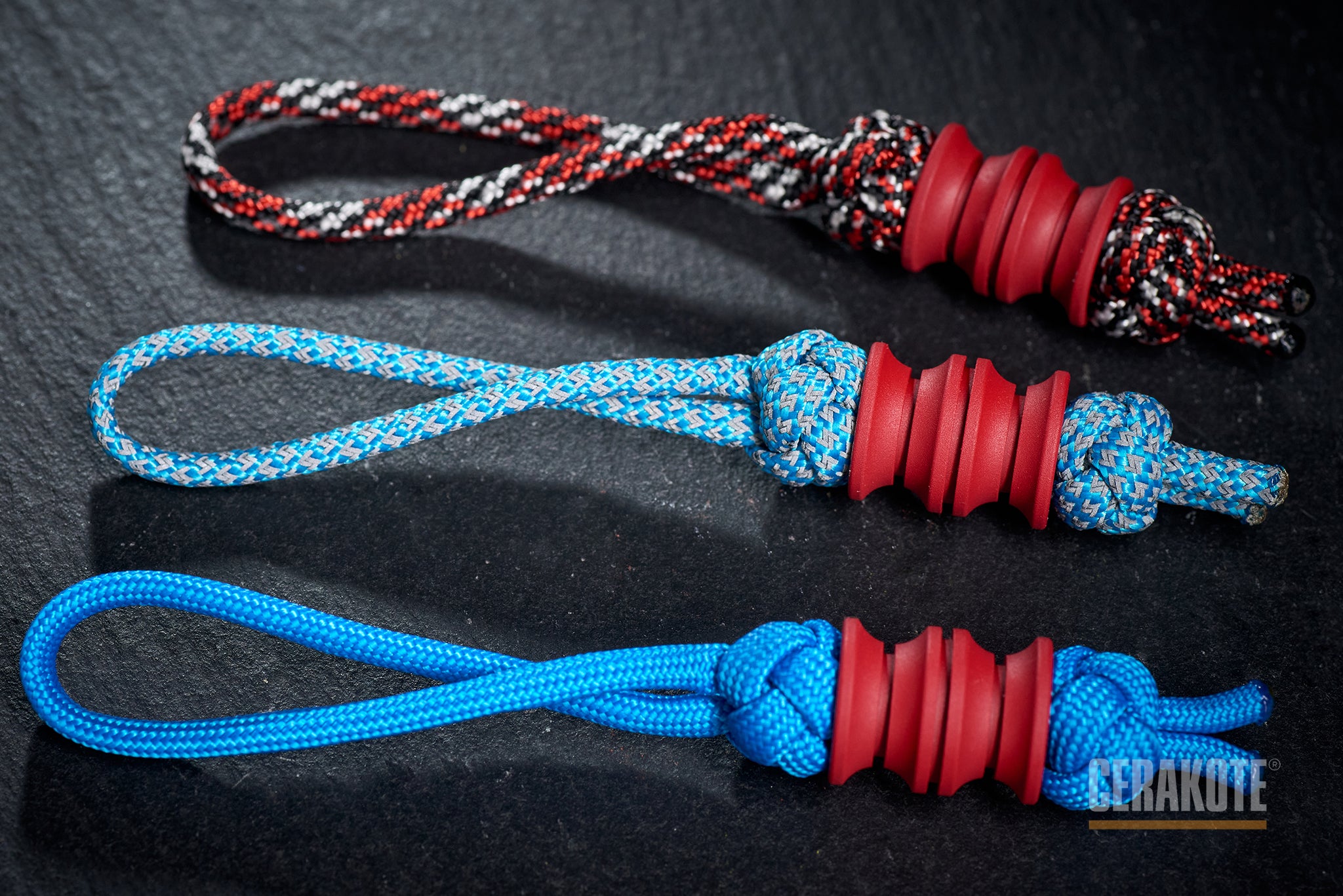 Red Grooved Barrel bead attached to a black paracord.-1