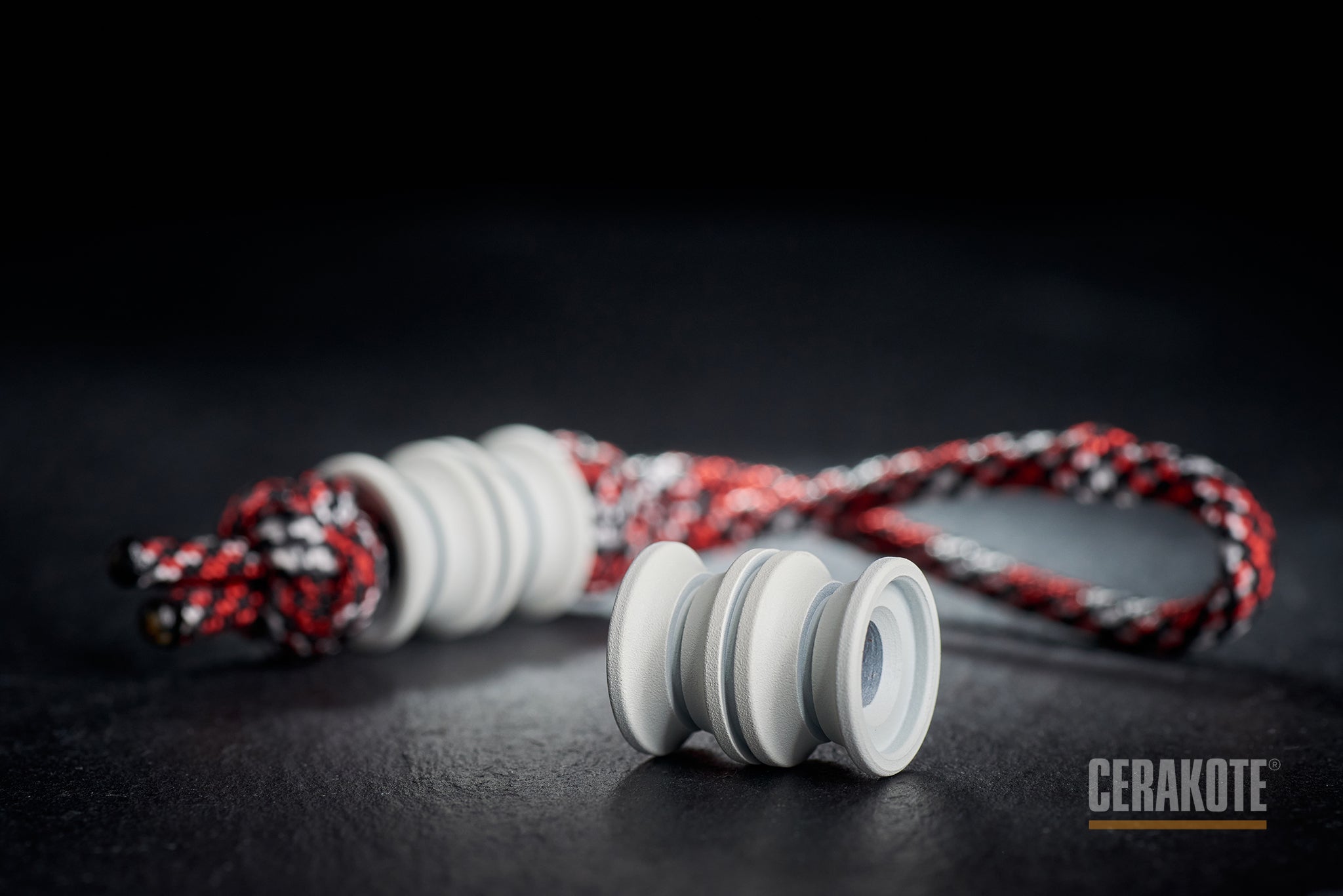 White Cerakote Grooved Barrel bead on a paracord lanyard.