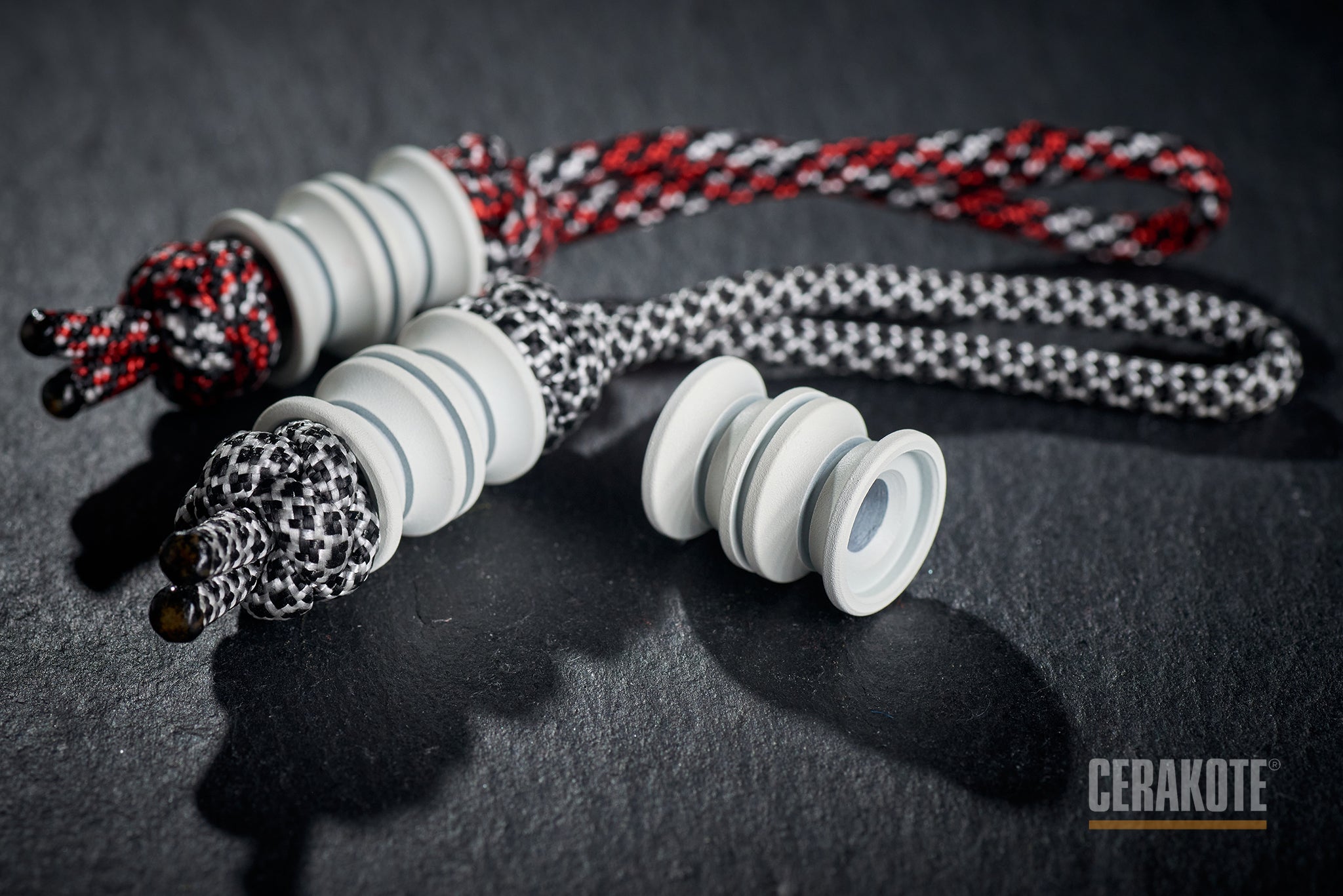 White Grooved Barrel bead attached to a black lanyard.