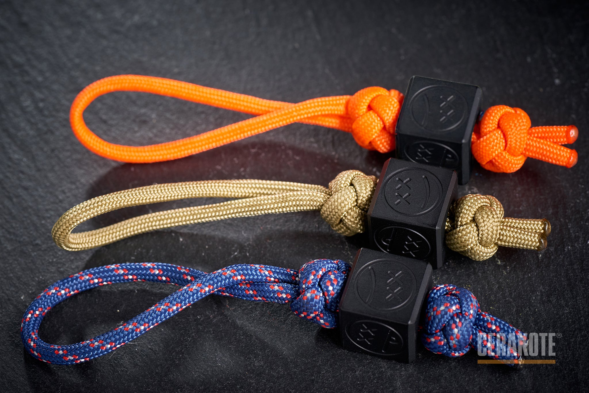Tactical blackout knife lanyard setup with a black Sad Face Cube.-1