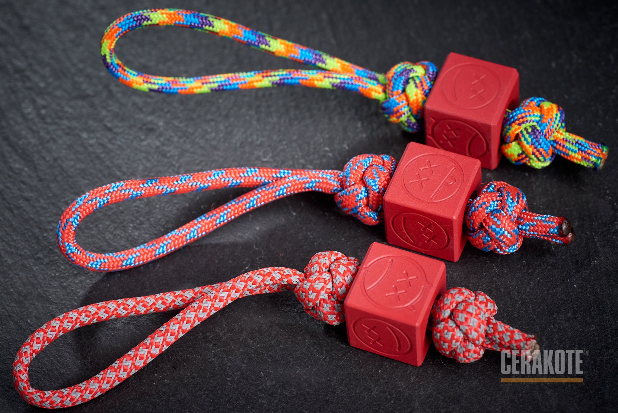 Red Sad Face Cube bead attached to a red paracord.-1