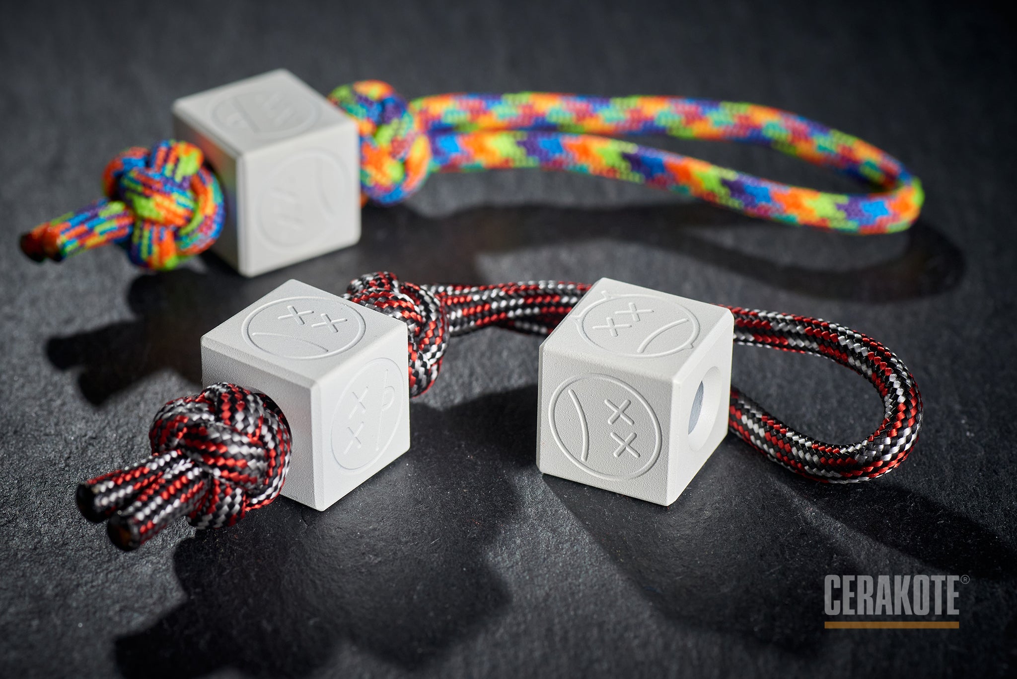 White Sad Face Cube bead attached to a red lanyard.