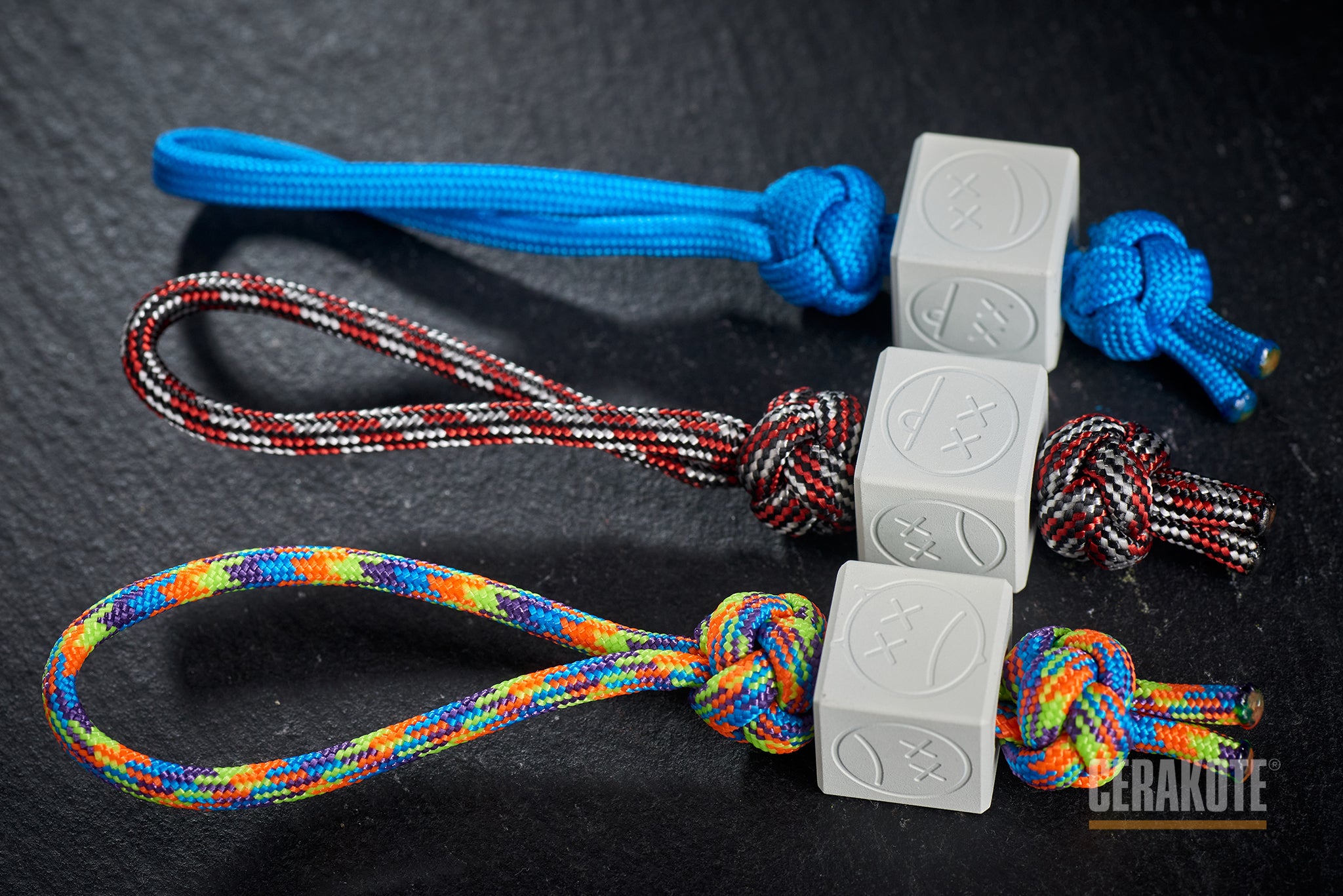 White Sad Face Cube bead attached to a blue lanyard.-1