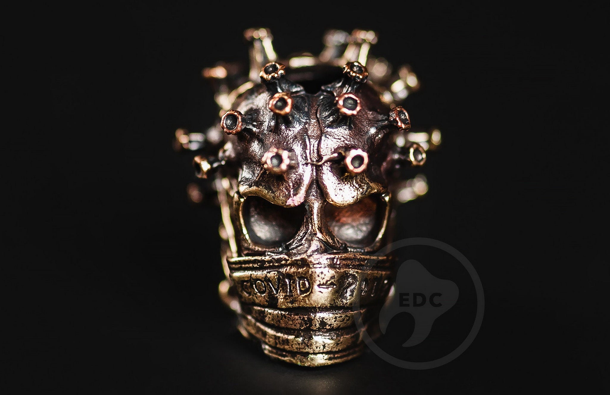 Close-up of the mutated spiked texture on the brass Toxic Skull bead.