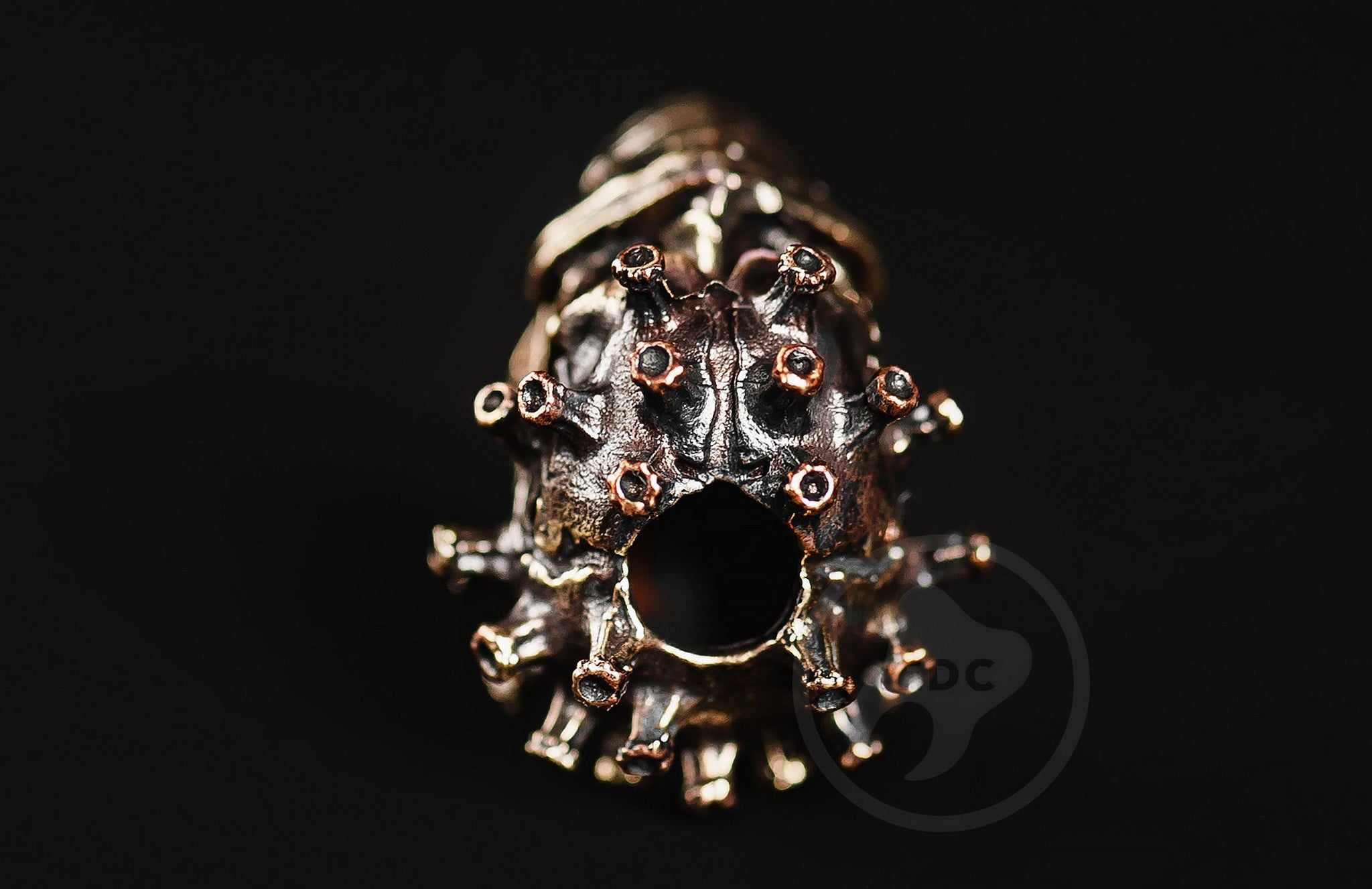 Profile view of the masked biohazard skull bead showing the antique blackened finish.-1