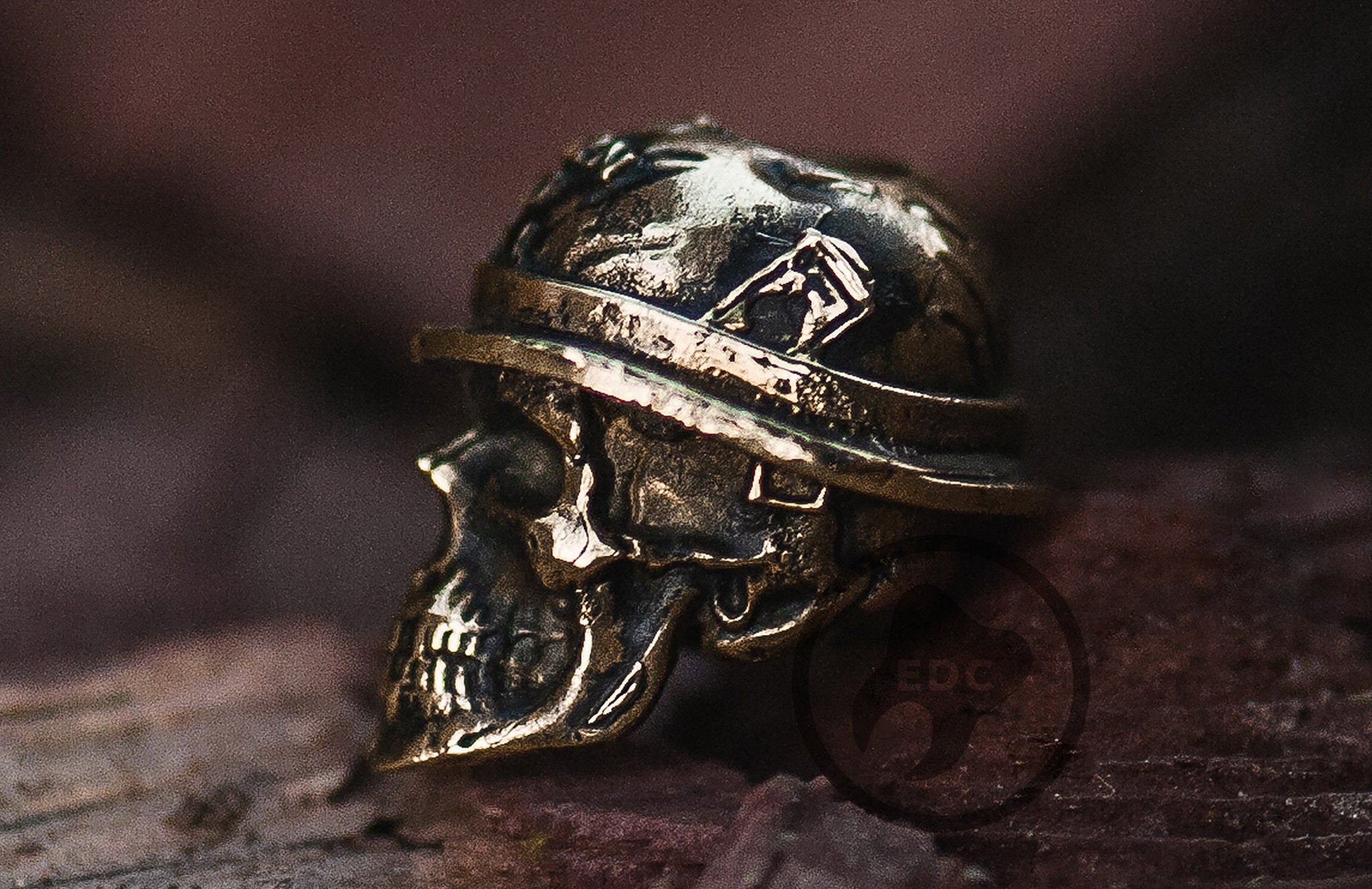 Hand-casted brass lanyard bead featuring a skull in a Vietnam War M1 helmet with "Born To Kill" text.-1