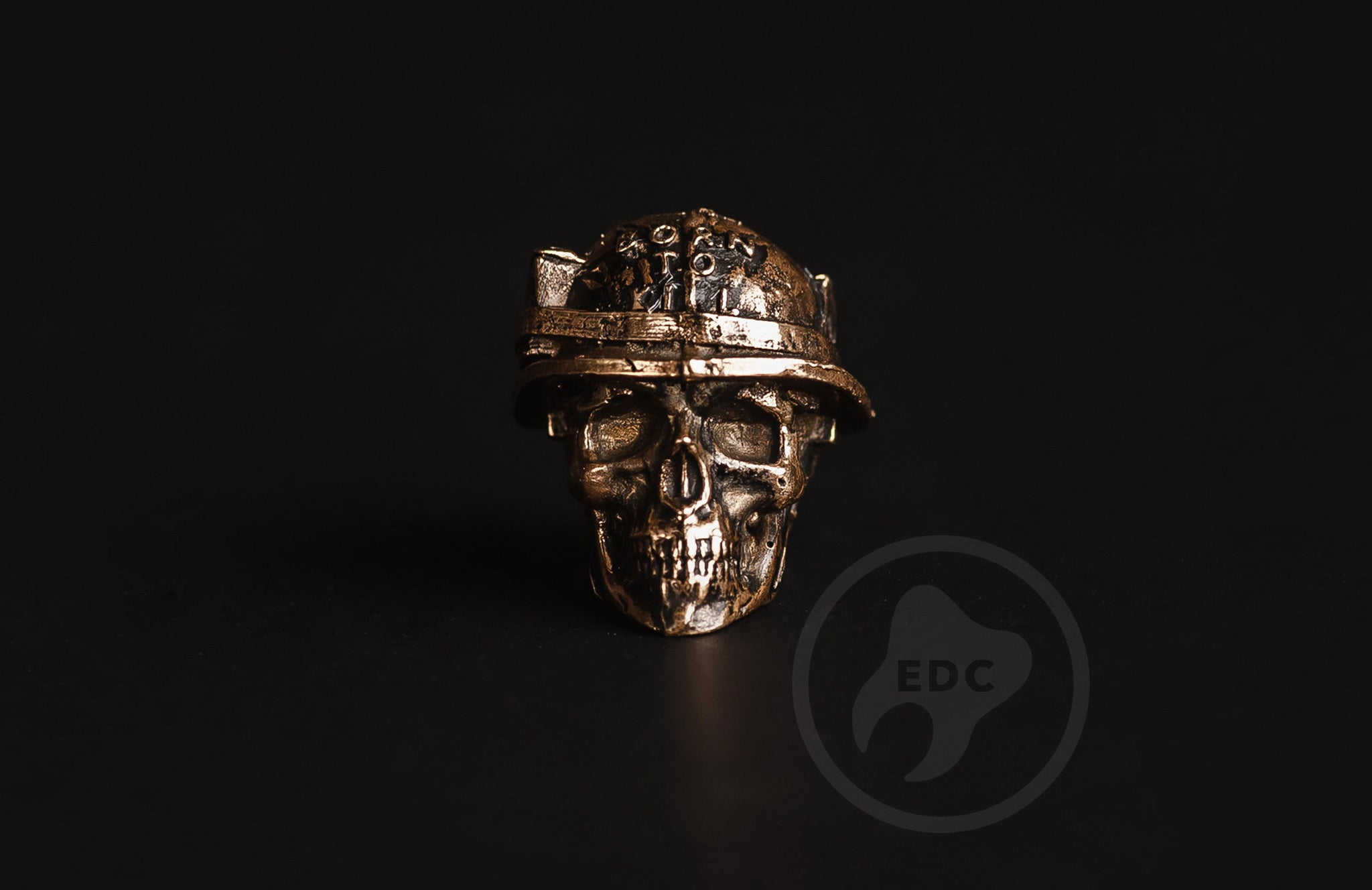 Close-up of the ammo belt and bullet details on the brass military skull bead.