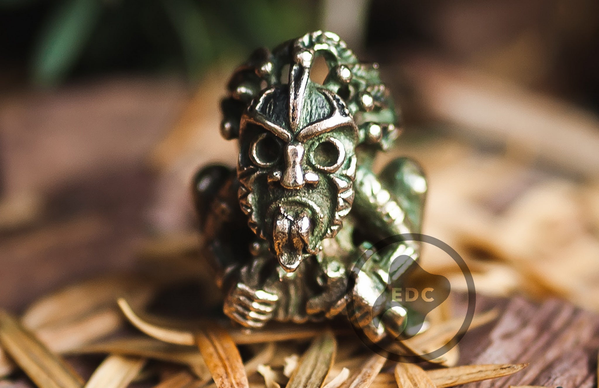 Close-up of the ritualistic details and blackened finish on the Shaman mask bead.