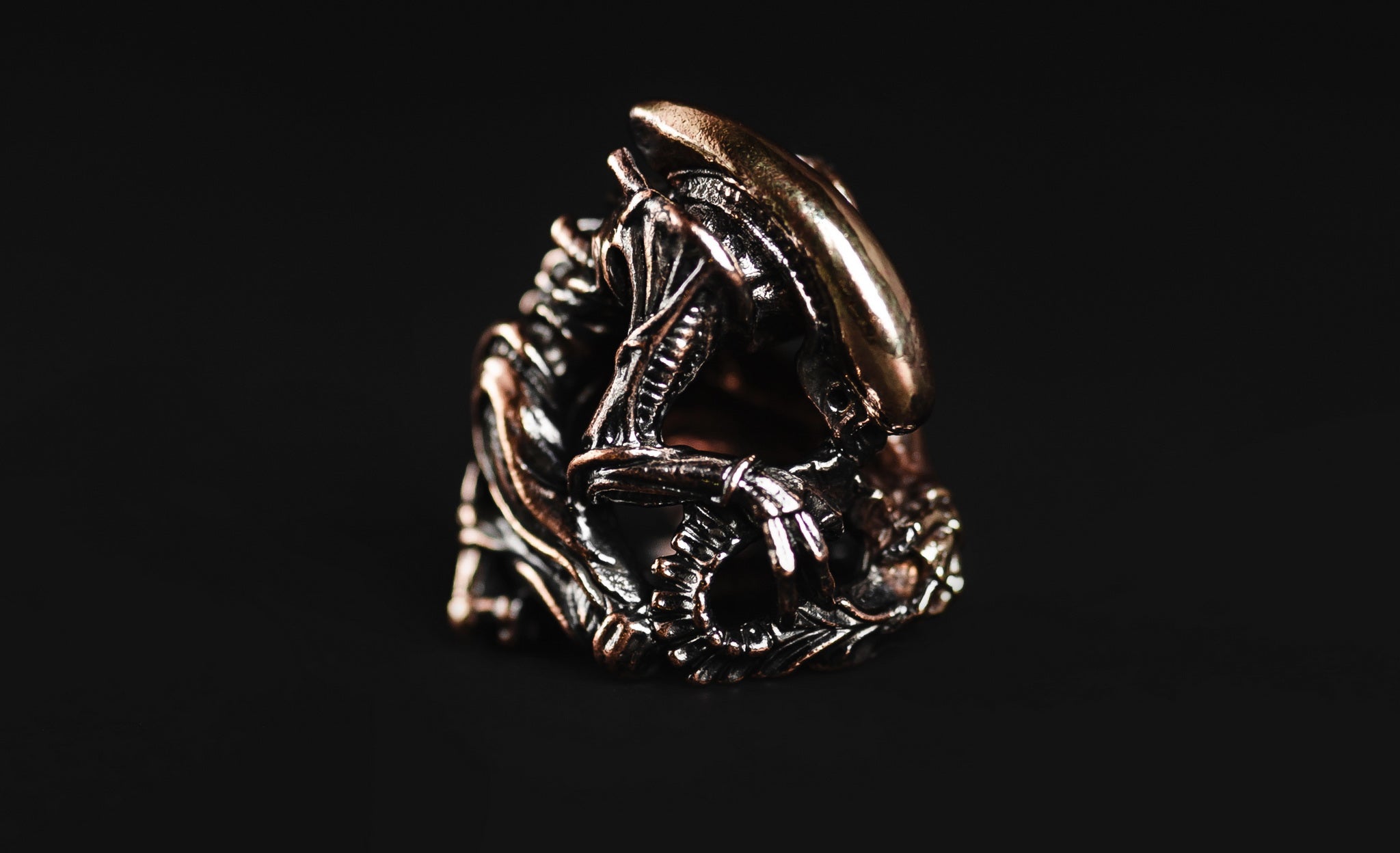 Hand-casted brass lanyard bead shaped like the Xenomorph Alien creature from sci-fi horror.