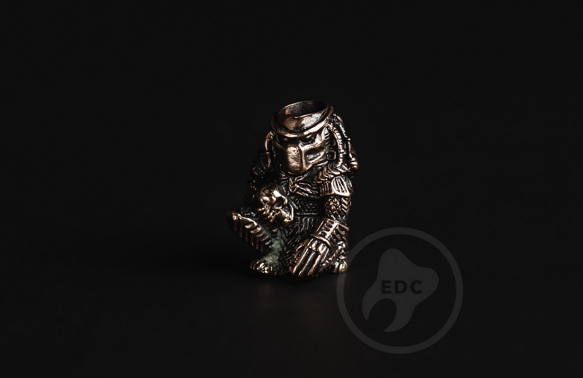 Close-up of the dreadlocks and bio-mask on the brass Predator bead.