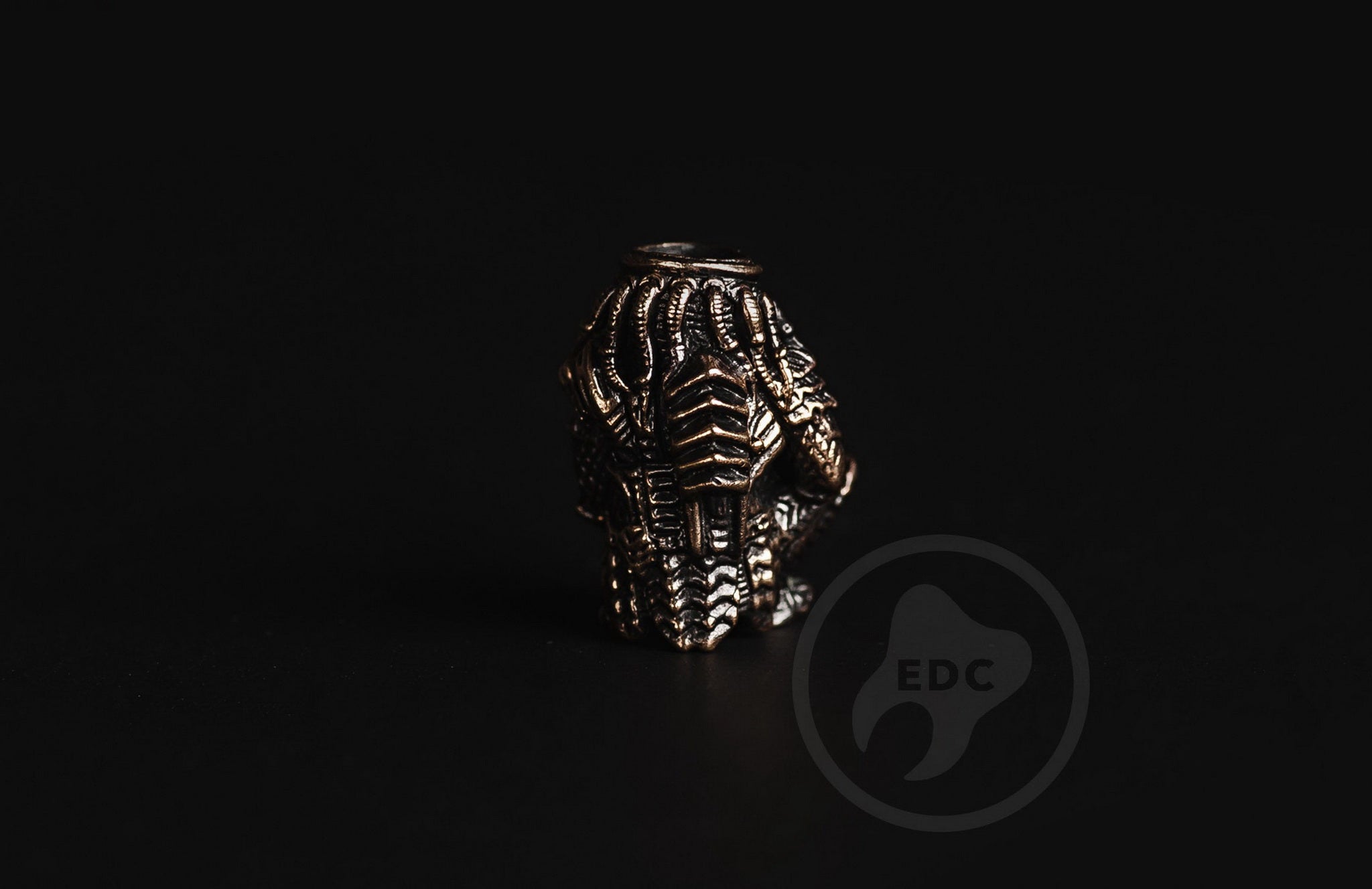 Close-up of the dreadlocks and bio-mask on the brass Predator bead.-1