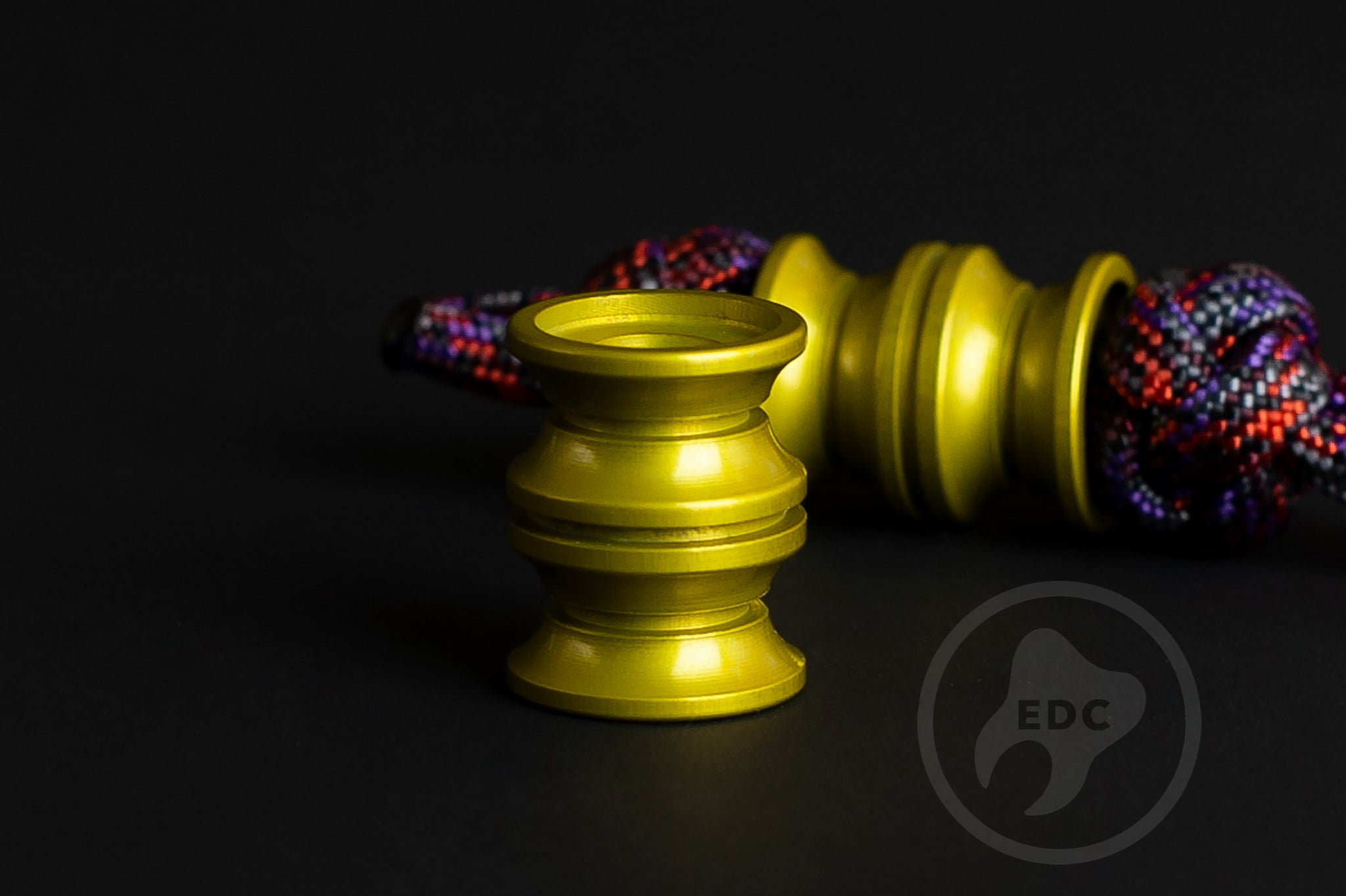 Professional EDC lanyard bead in vibrant yellow anodized aluminum finish.